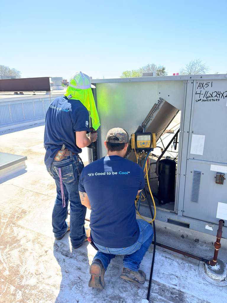 Cool Bear technicians diagnosing a commercial rooftop AC unit