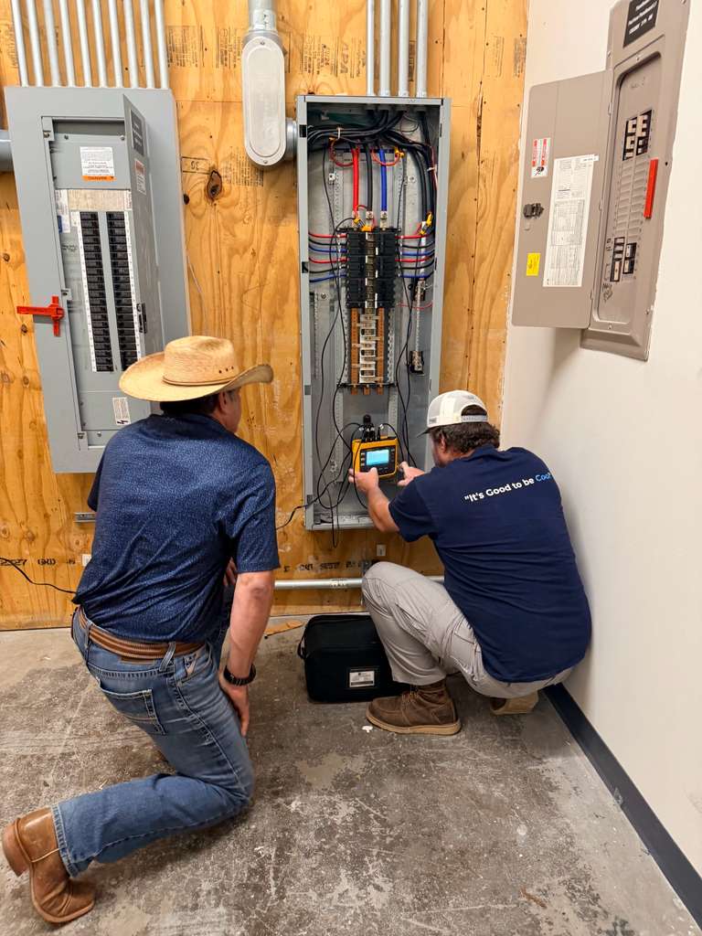Cool Bear technicians working on electrical panel